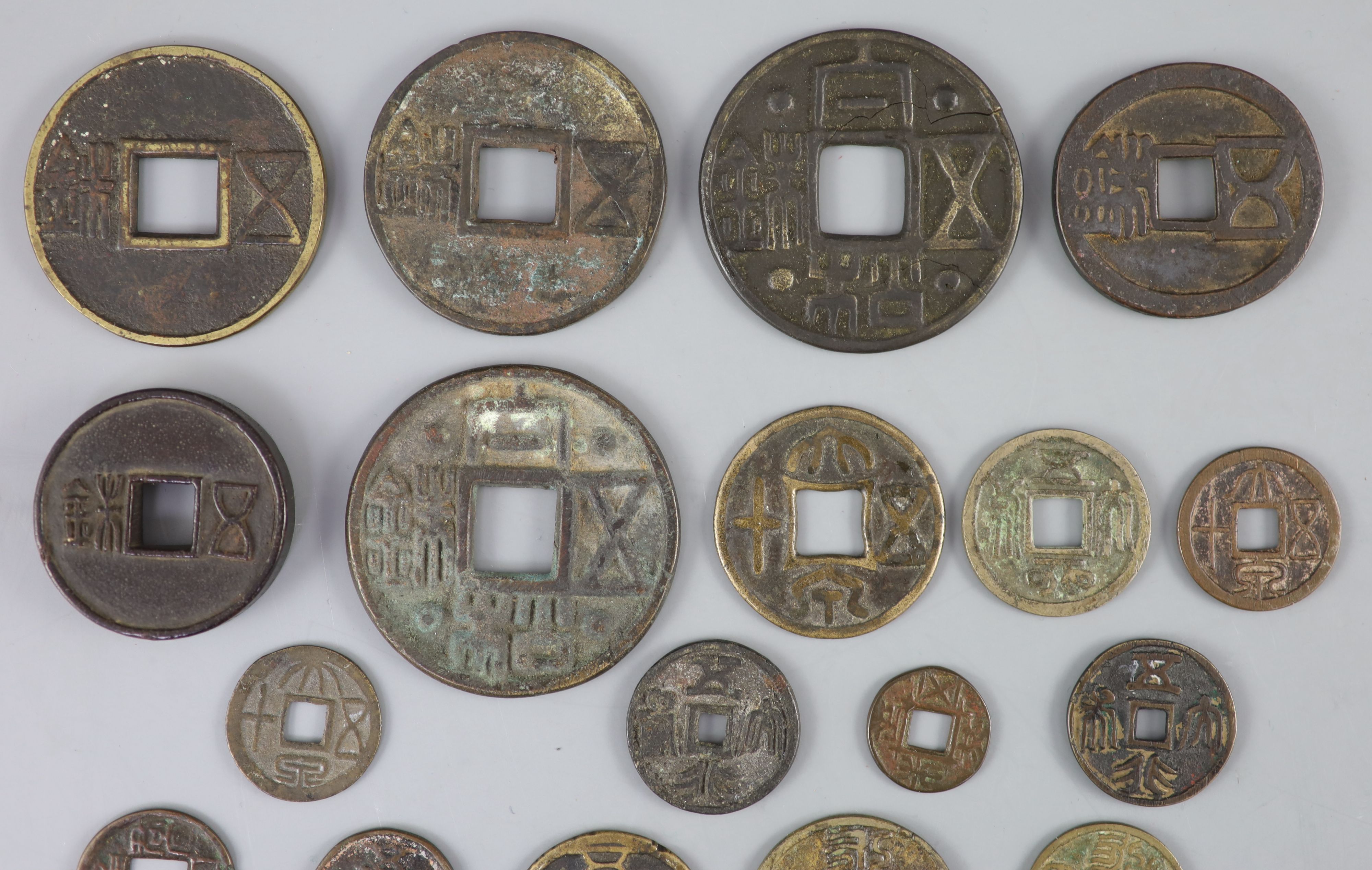 China, a group of 6 bronze coin charms or amulets, 19th century and various Thai (Siamese) porcelain gaming counters,